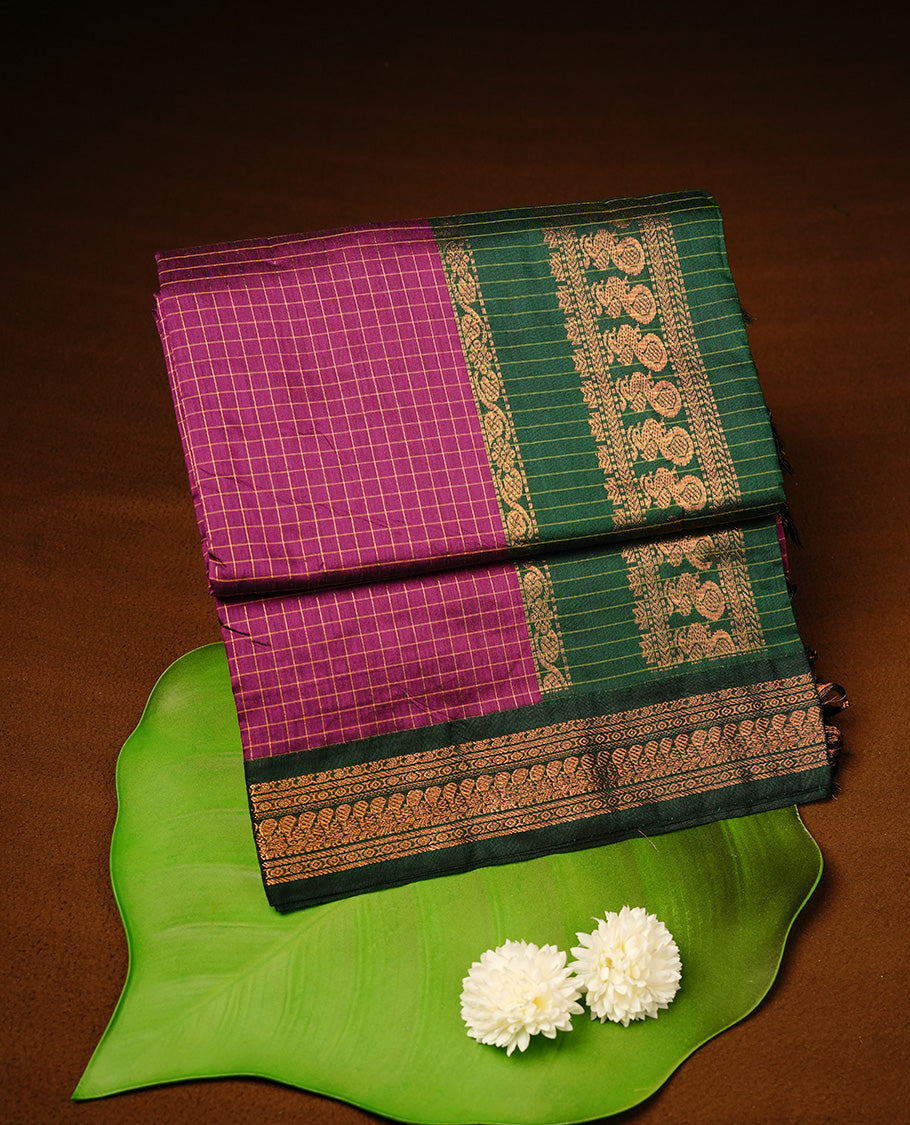 Purple colour kalyani cotton saree featuring gold zari check pattern on body, highlighting contrast green colour with Antique gold zari border, paired with matching blouse piece.