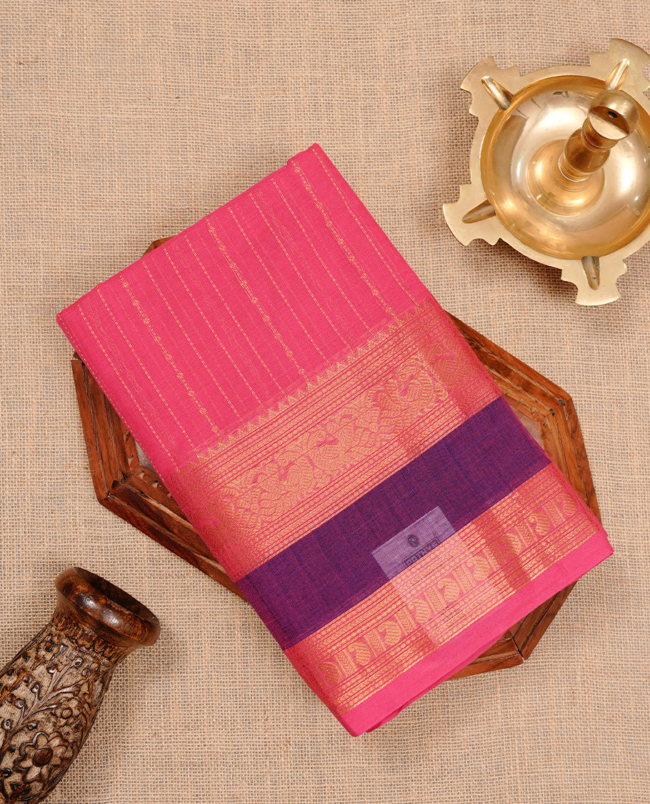 Magenta colour chettinad cotton saree featuring gold zari stripes on body, complemented by purple colour with zari border, paired with matching blouse piece.