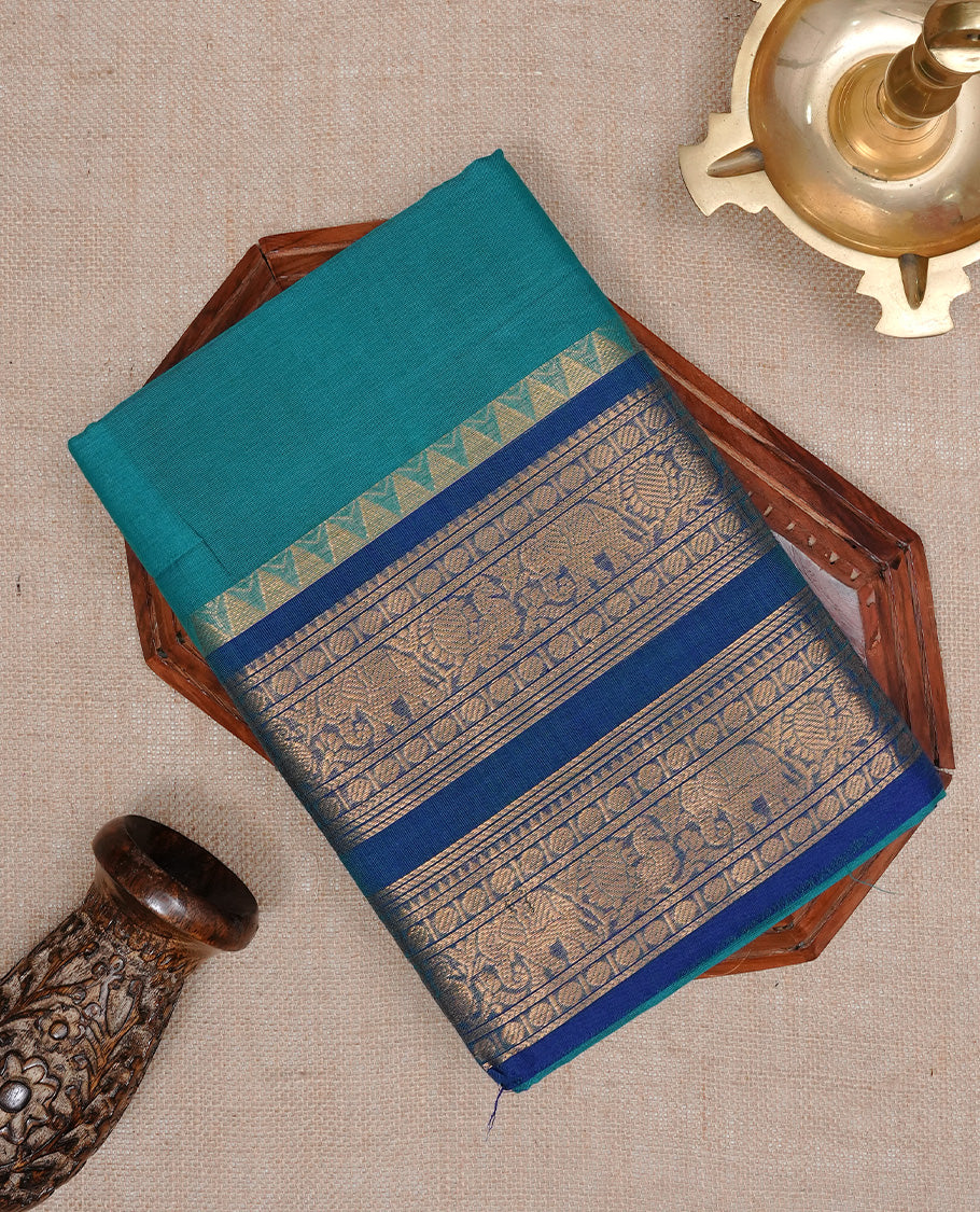Aqua colour Chettinad cotton saree featuring Elegant plain body, complemented by contrast Teal colour with Gold zari border, paired with matching blouse piece.