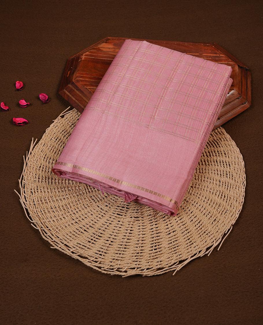 Baby pink colour semi Tussar saree highlights gold zari check pattern across body, border, pallu and paired with matching blouse piece.