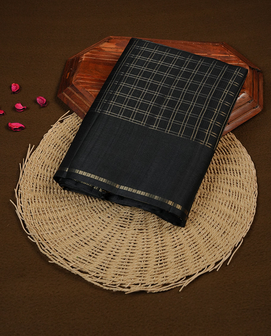 Black colour semi Tussar saree highlights gold zari check pattern across body, border, pallu and paired with matching blouse piece.