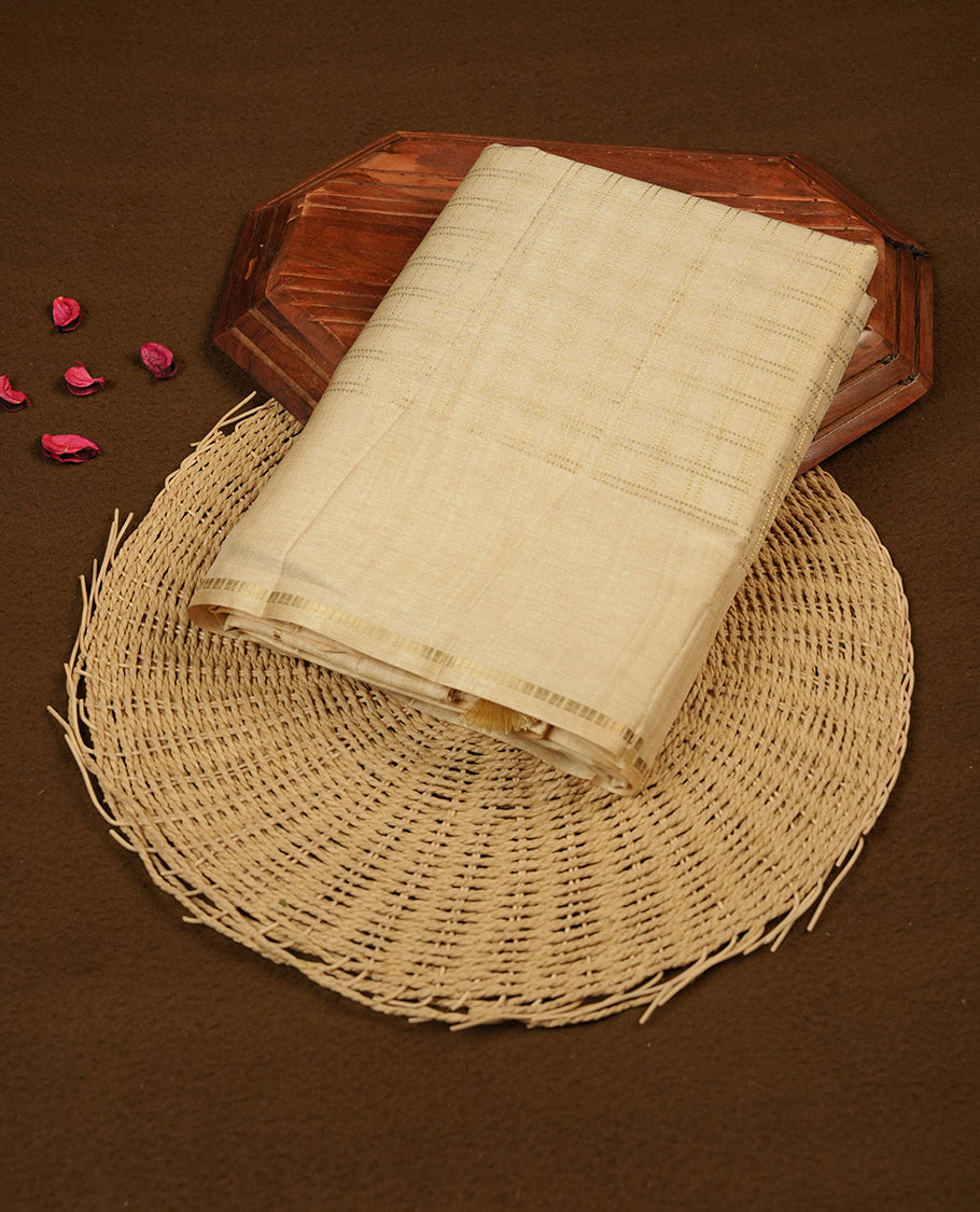 Cream colour semi Tussar saree highlights gold zari check pattern across body, border, pallu and paired with matching blouse piece.