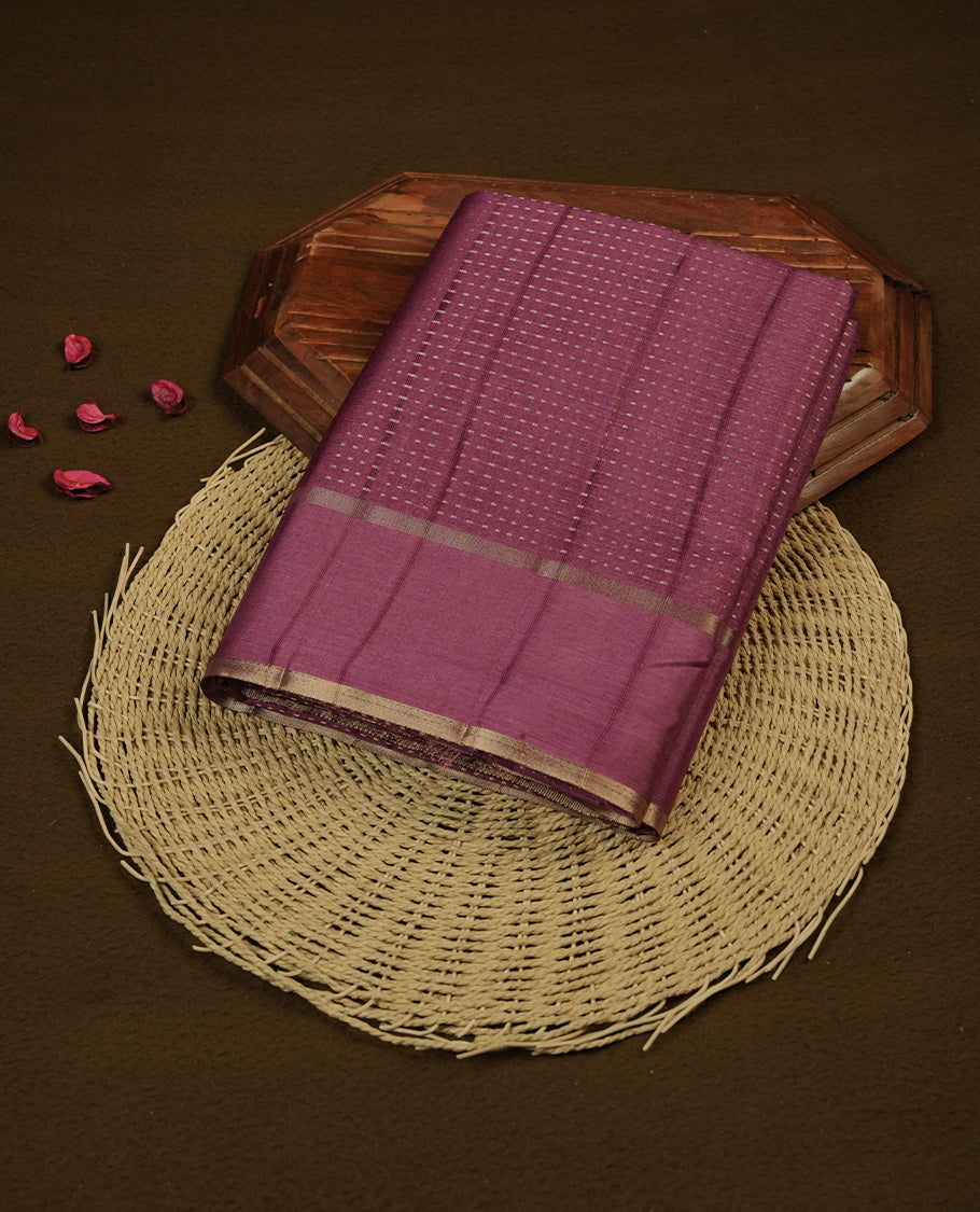 Mauve taupe colour semi tussar silk saree highlighting gold zari dotted stripes, self colour border and contrast dark mauve taupe pallu and comes with matching blouse piece.