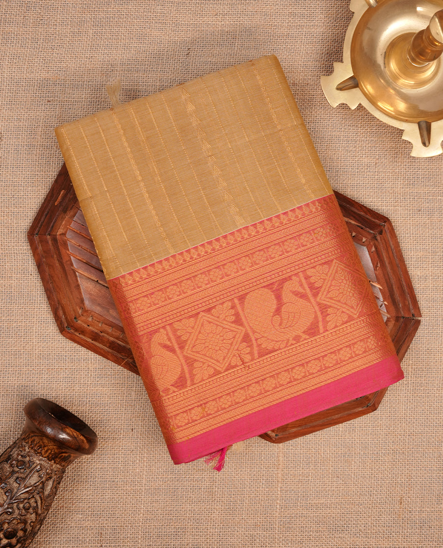 Beige colour chettinad saree featuring gold zari stripes on body, complemented by contrast Magenta colour with traditional border, paired with matching blouse piece.