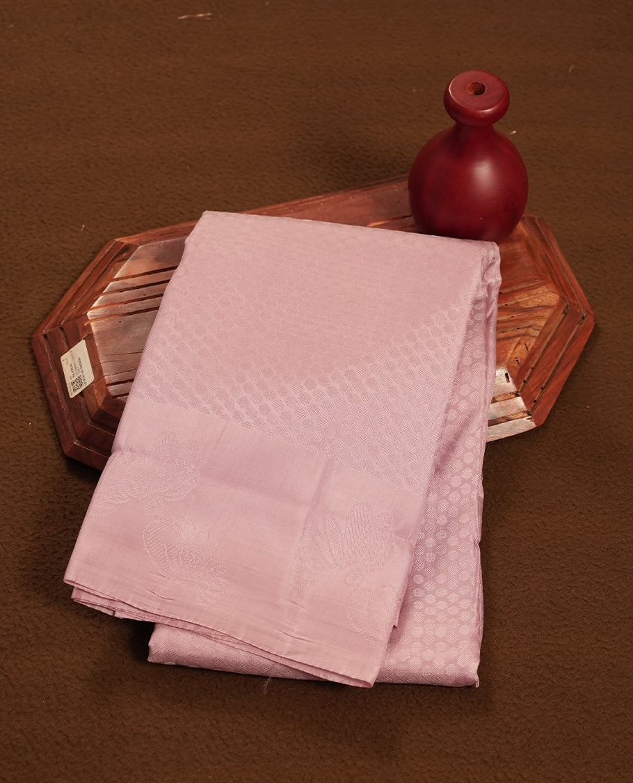 pastel purple colour semi-soft silk saree featuring a self coloured textured patterned body, complemented by self coloured motifs on pallu & border and a matching blouse piece.