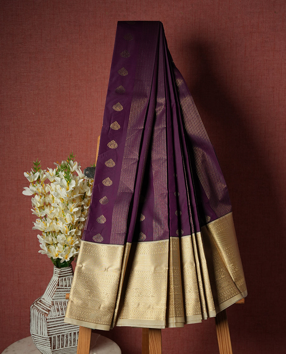 Grape purple colour Semi Silk Saree with gold zari striped patterns on the body, paired with a contrasting cream colour traditional pallu and border, and a matching blouse piece.