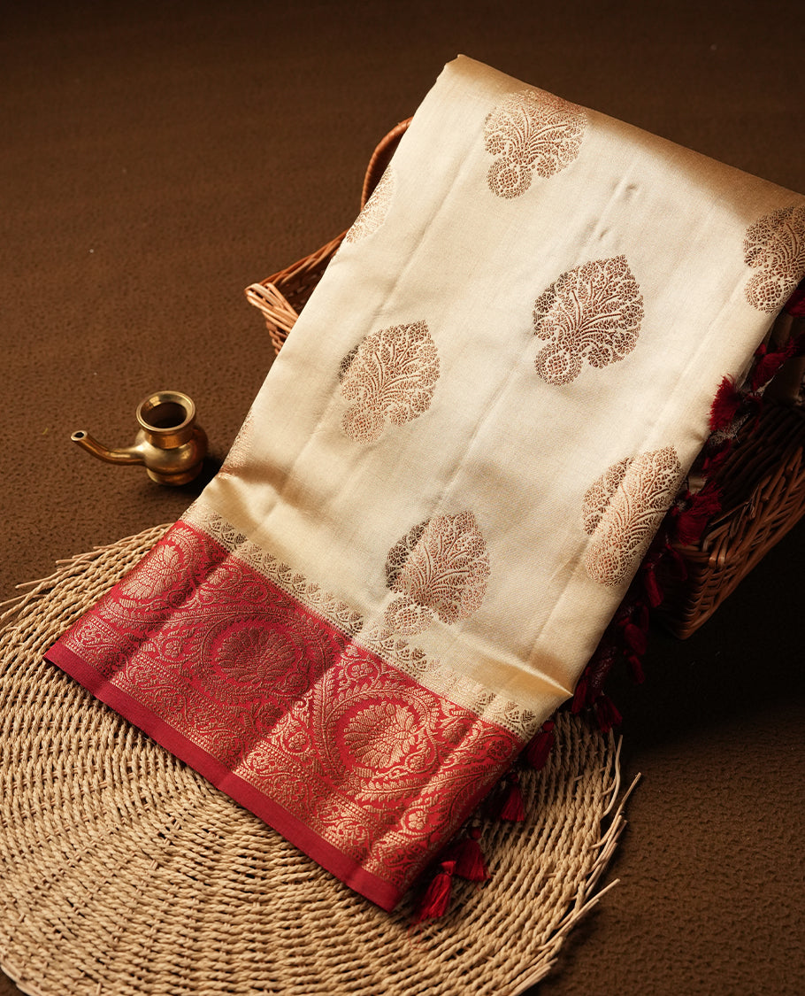 Cream beige Banaras soft silk saree with gold zari oval motifs on body, with contrast Red colour floral pattern on pallu, border, and Matching blouse.