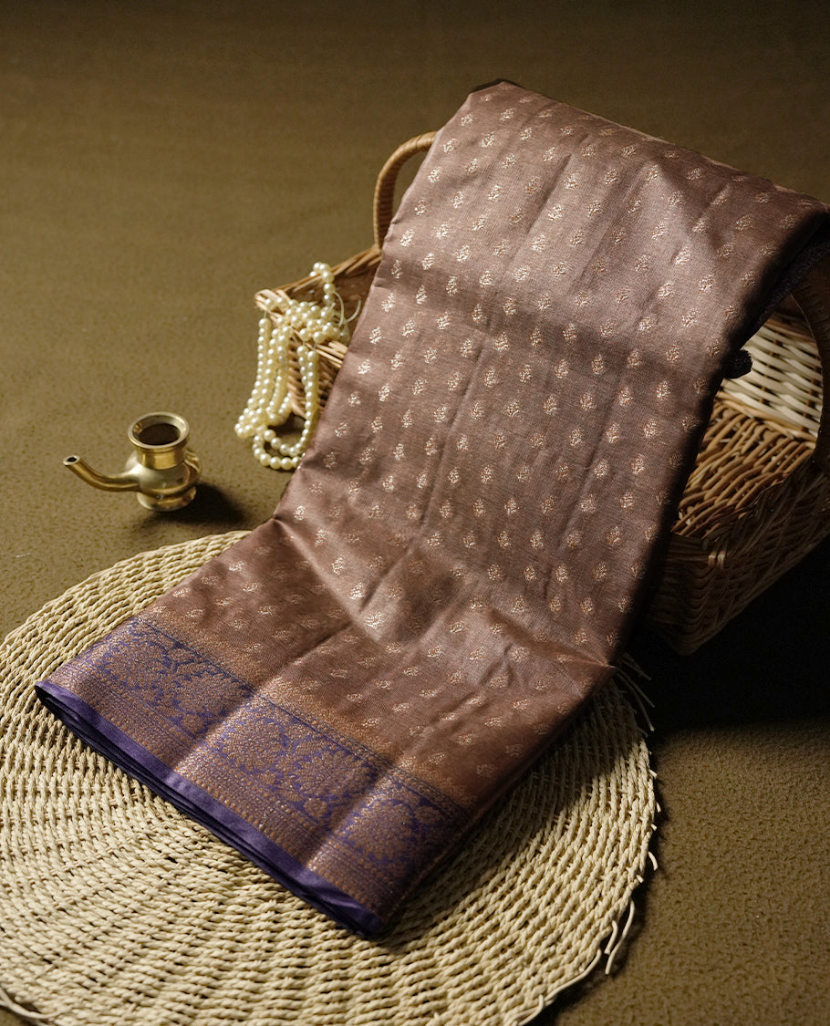 Brown pure banarasi tussar saree featuring fine silver zari motifs across the body, accentuated with an elegant contrast purple Banarasi border & Paired with a matching blouse piece.