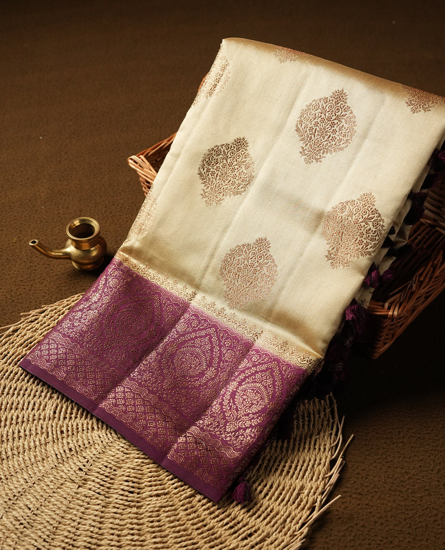 Cream beige Banaras soft silk saree with gold zari oval motifs on body, with contrast Maroon colour floral pattern on pallu, border, and Matching blouse.