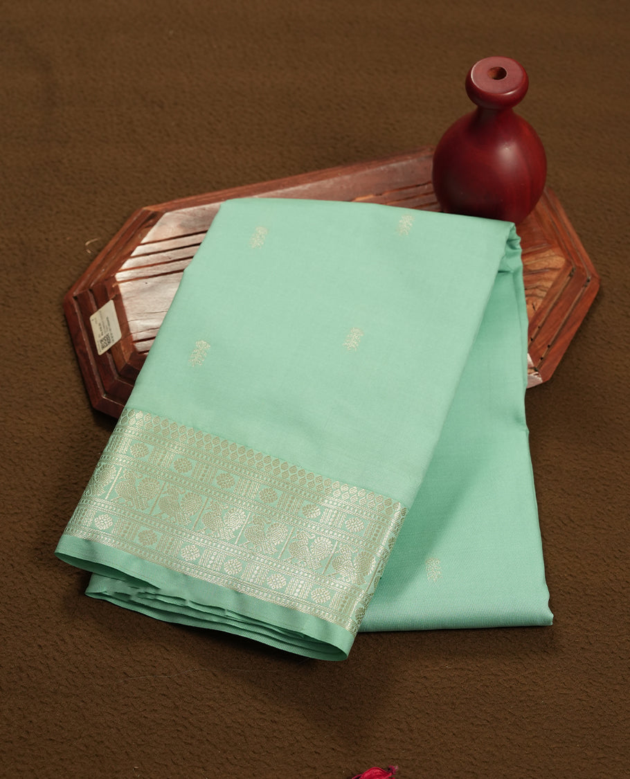 Light aqua colour semi soft silk saree featuring a gold patterned body, complemented by Gold colour traditional pallu and a matching blouse piece.