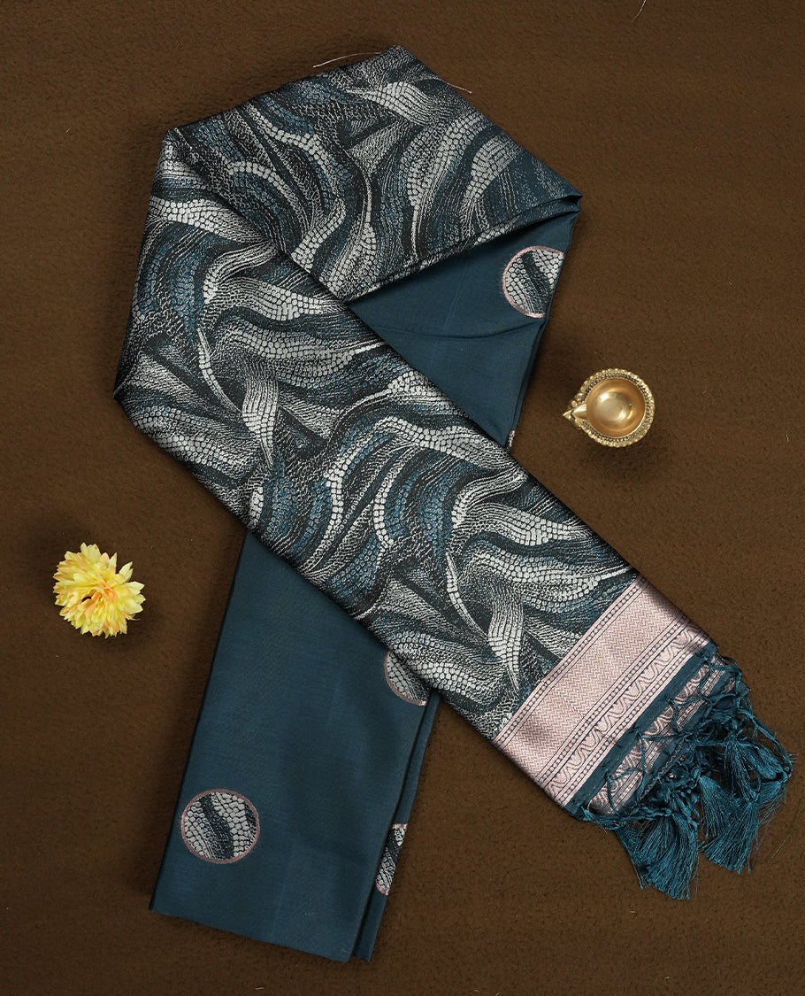 Dark green semi silk saree featuring elegant circular motifs on the body, complemented by a striking pallu adorned with intricate wavy white thread patterns with golden border, and paired with a matching blouse