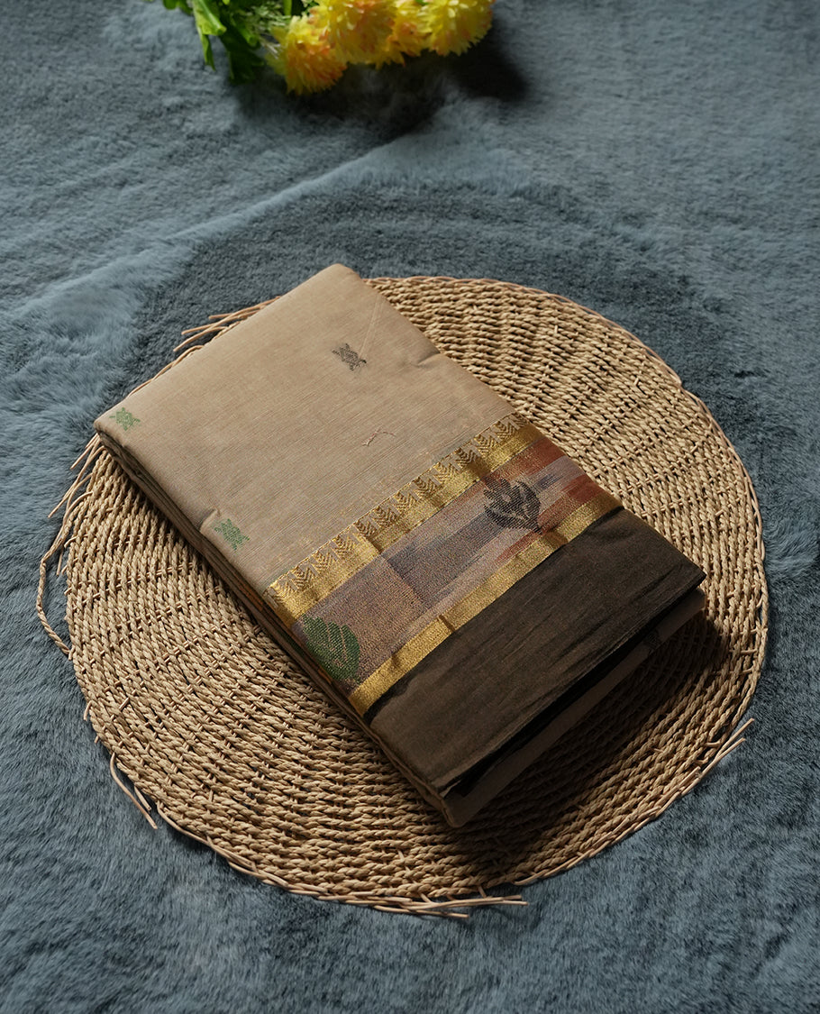 Beige Sand colour Silk Cotton Saree with Pastel Green Floral-Jacquard Pallu Panels and Chevron Bands, Body dotted with tiny thread buttas, Antique Gold Ikat-inspired border over Deep Olive lower edge, and a Plain Beige Sand Blouse with Matching