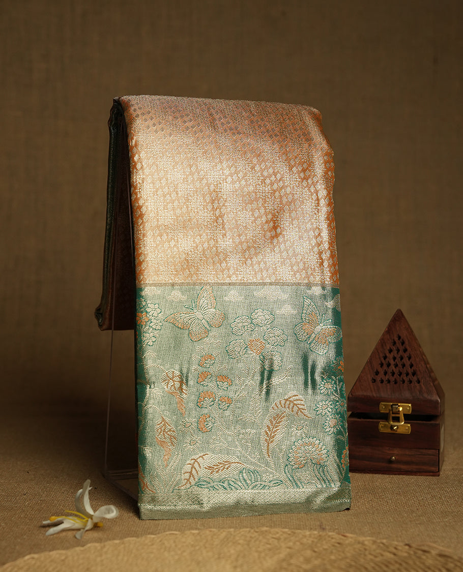 Saffron colour and Antique gold Zari Tissue Brocade Saree features intricate floral Motifs on body and fancy border & pallu with floral patterns, paired with matching blouse