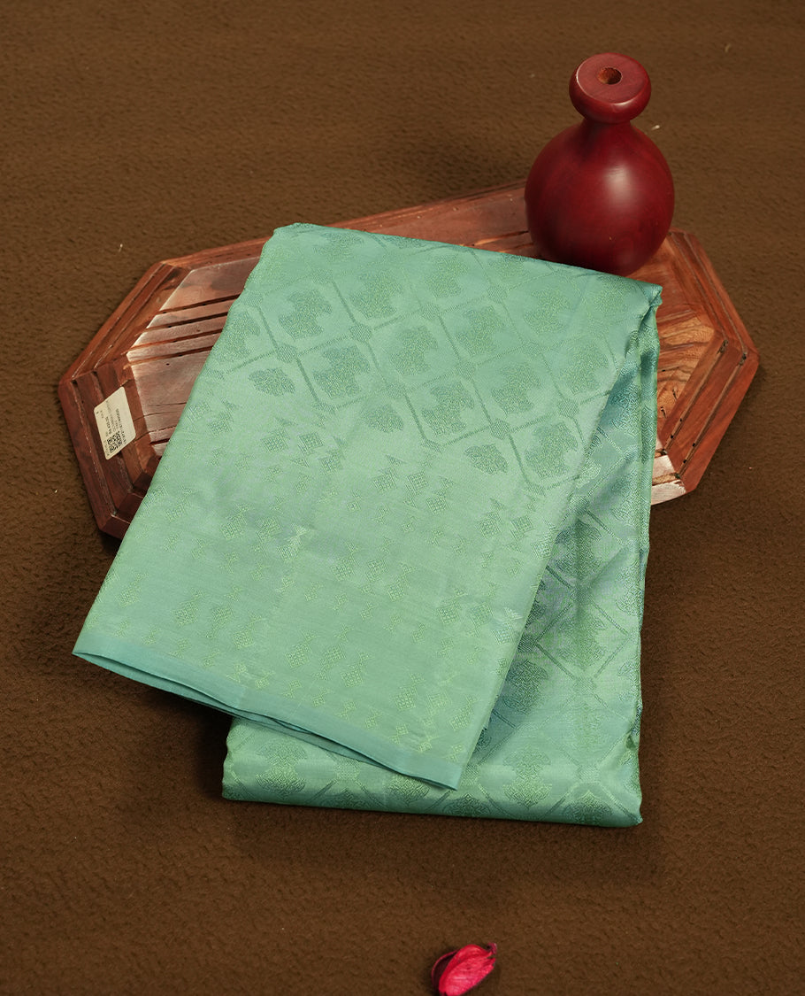 Mint Green colour semi soft silk saree featuring a self coloured textured square motufs on body, complemented by self coloured Square motifs pallu & border and a matching blouse piece.