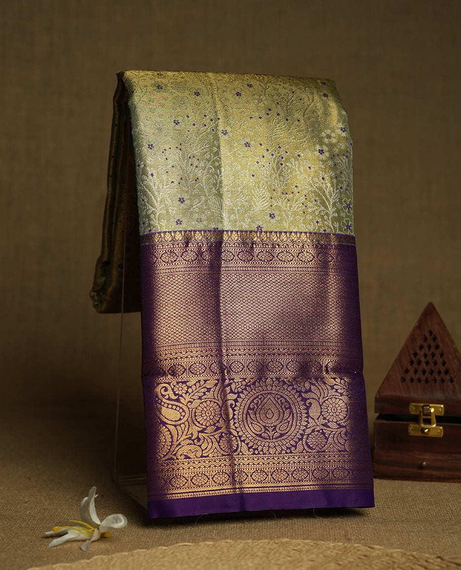 Pastel green and Antique silver Zari Tissue Brocade Saree features intricate coloured floral Motifs on body and a navy blue colour with traditional border & pallu, paired with matching blouse