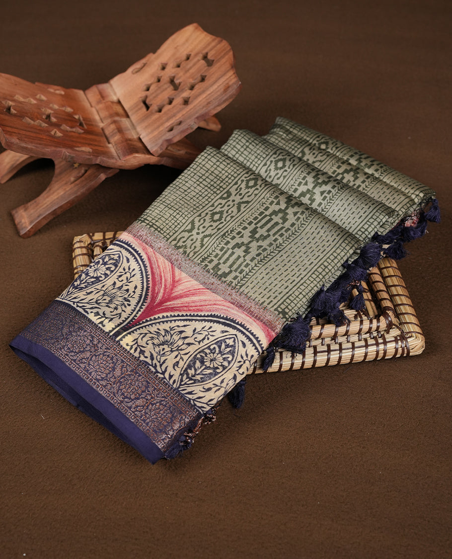 Greenish Gray colour chanderi silk saree featuring geometric print pattern across body, with contrast Blue colour border with zari pattern and paired with matching blouse.