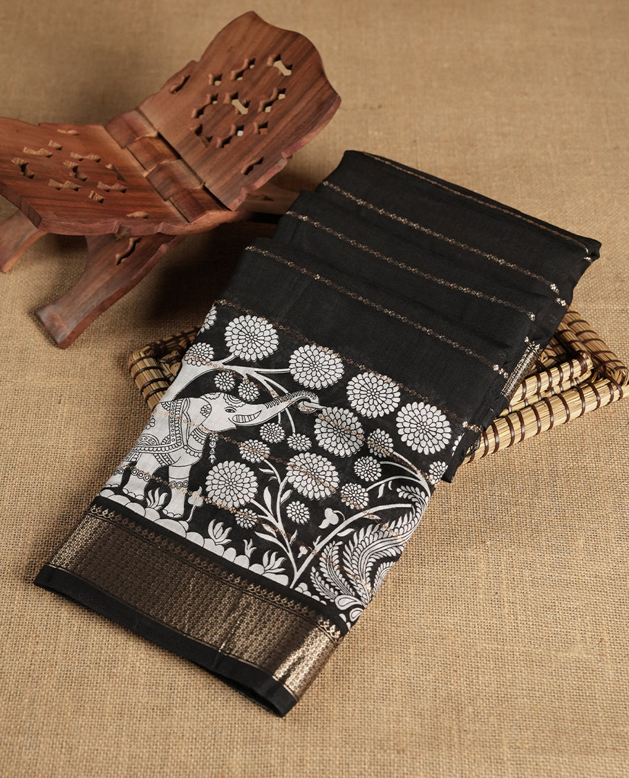 Black colour chanderi silk saree with gold zari strip pattern On body, compilmented by self colour border with antique zari pattern & white animal & forest print pattern and a matching blouse.