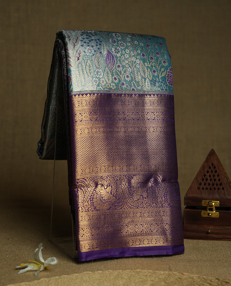 Sky blue colour and Antique gold Zari Tissue Brocade Saree features intricate coloured floral Motifs on body and a blue colour with traditional border & pallu, paired with matching blouse