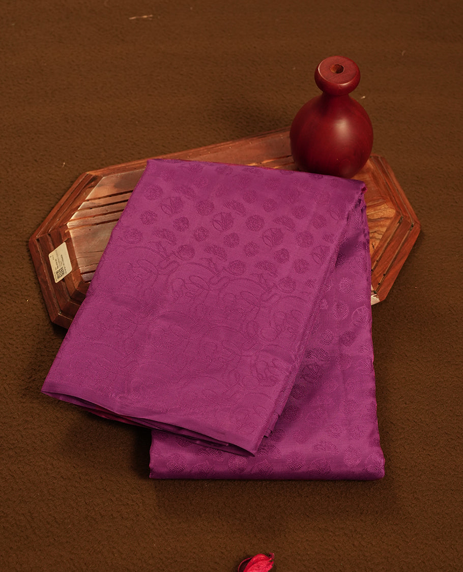 Radish colour semi soft silk saree featuring a self coloured textured patterned body, complemented by self coloured pallu & border and a matching blouse piece.