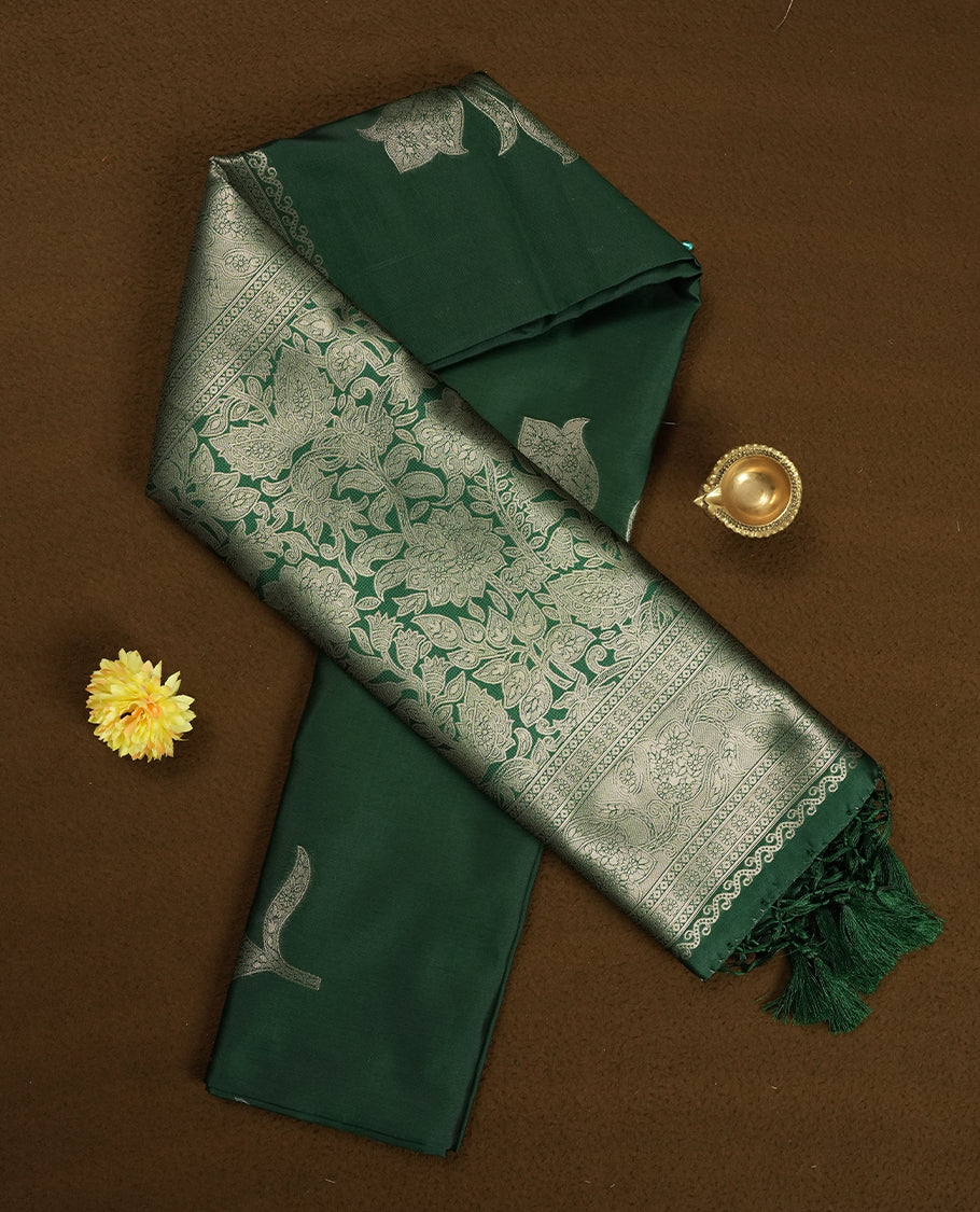 Bottle Green Semi Silk Saree with Silver Zari Floral Woven Pallu and Border, Subtle Zari Butta Motifs on the Body, Tassel Detailing, and Coordinated Blouse Piece