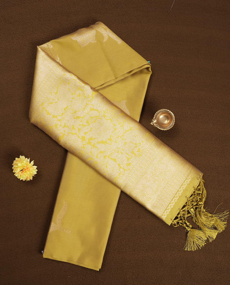 Mustard Yellow Semi Silk Saree with Matching Zari Woven Pallu and Border Featuring Subtle Floral Patterns, Tassel Detailing, and Coordinated Blouse Piece