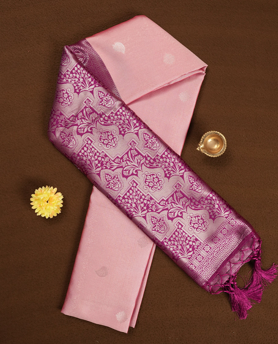 Light pink colour semi silk saree adorned with silver leaf motifs on the body, complemented by a purple pallu intricately woven with rich floral patterns border and pallu, and paired with a matching blouse