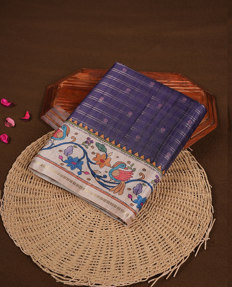 Violet colour semi tusser silk saree featuring gold zari check pattern with floral butti motifs, with contrast floral kodi & bird pattern and paired with matching blouse.