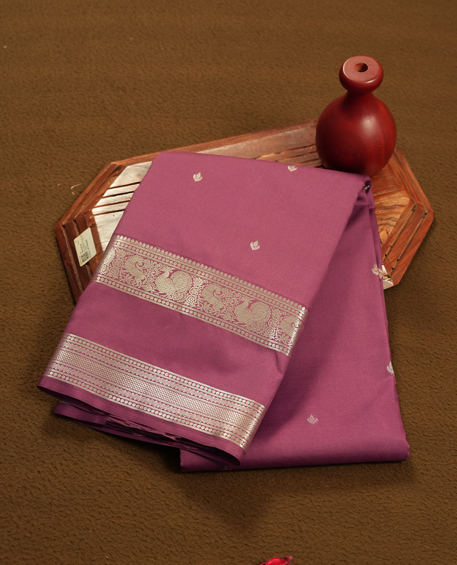twilight lavender colour semi soft silk saree featuring a gold colour textured patterned body, complemented by self coloured golden motifes on pallu & border and a matching blouse piece.
