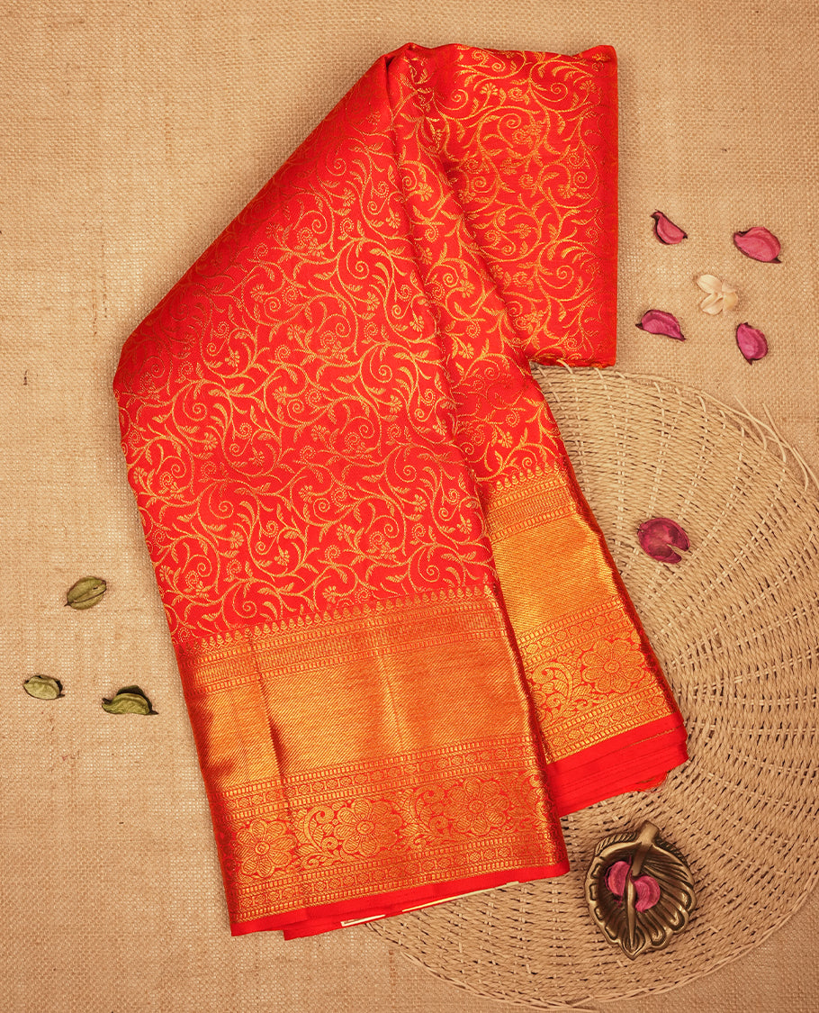 Red colour Kanchipuram Samudrika Silk Saree featuring Floral kodi pattern weaving with gold zari jacquard and a traditional zari border, paired with a matching designer jacquard blouse piece