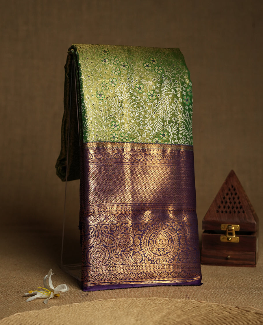Light green colour and Antique silver Zari Tissue Brocade Saree features intricate a floral Motifs on body and a deep violet colour border & pallu with floral patterns, paired with matching blouse
