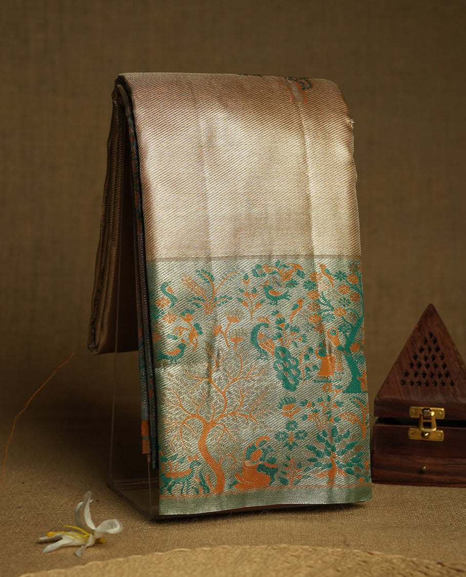 Golden colour Zari Tissue Brocade Saree features intricate tree Motifs on body and fancy border & pallu with floral patterns, paired with matching blouse