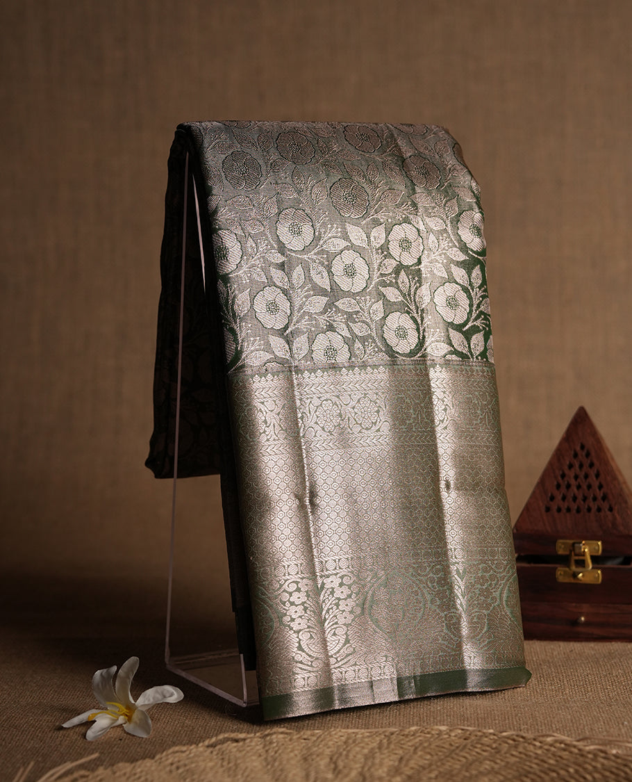 Dull green colour and Antique gold Zari Tissue Brocade Saree features intricate floral Motifs on body and fancy border & pallu with floral patterns, paired with matching blouse