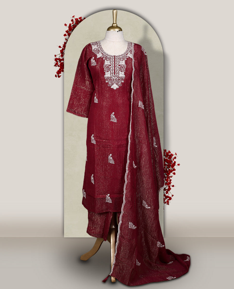 Maroon churidar set featuring elegant white thread embroidery on the neckline, sleeves, and scattered motifs across the body, Paired with a matching embroidered dupatta, this ensemble radiates graceful charm and festive appeal.