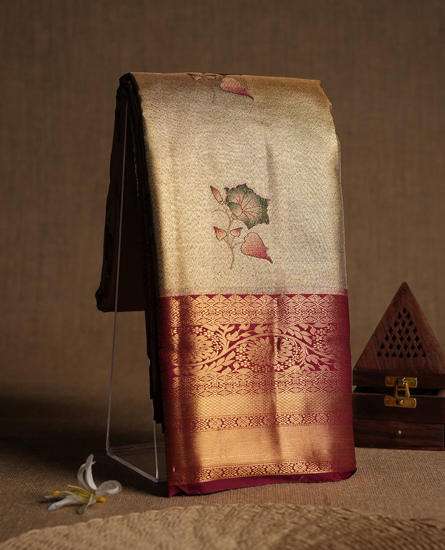 Antique golden Zari Tissue Brocade Saree features intricate green colour flower Motifs on body and a dark red colour border & pallu with traditional patterns, paired with matching blouse