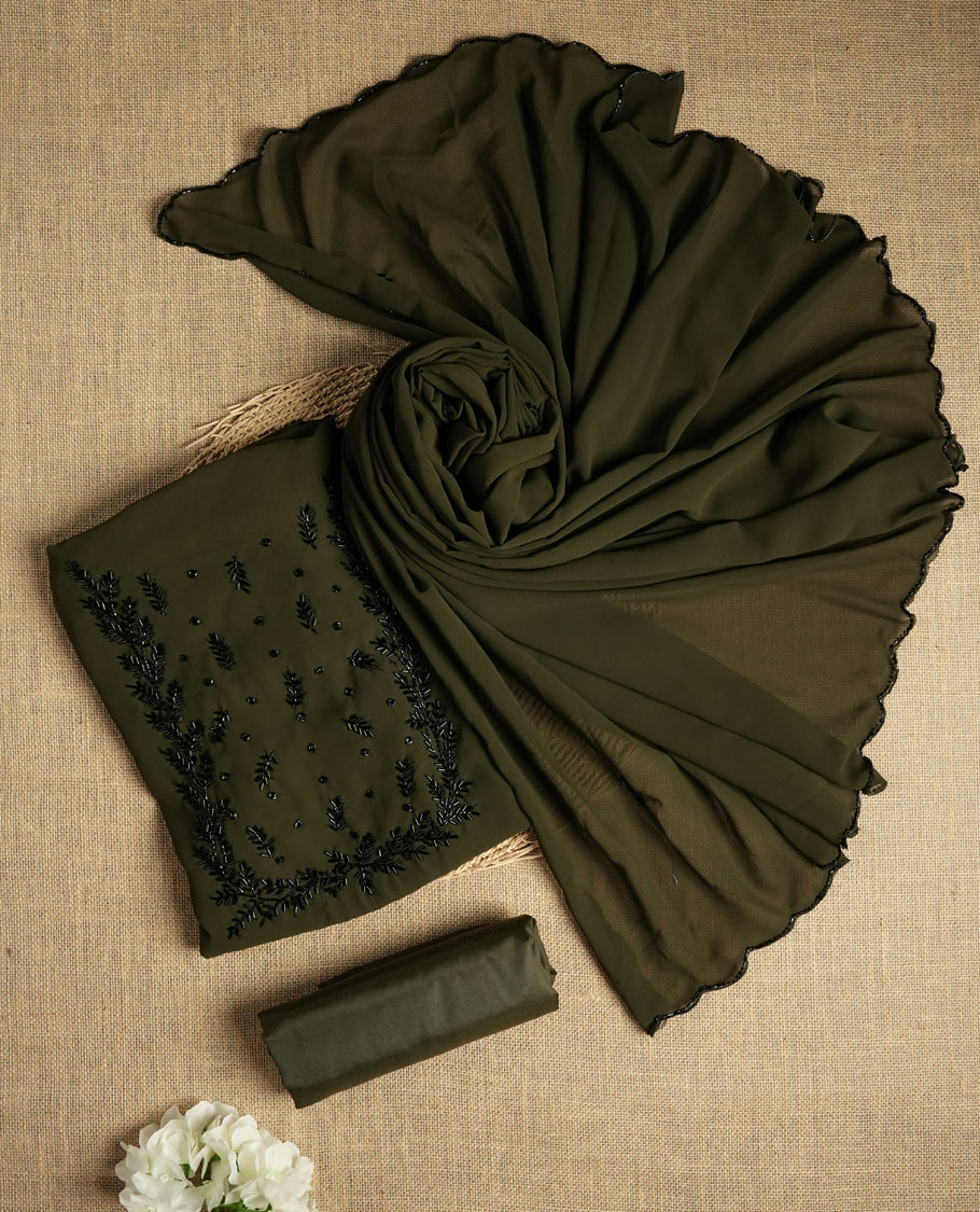 Dark Olive green colour suit material adorned with intricate black cut beads work, exuding sophisticated charm & paired with a soft dupatta and a matching plain bottom.