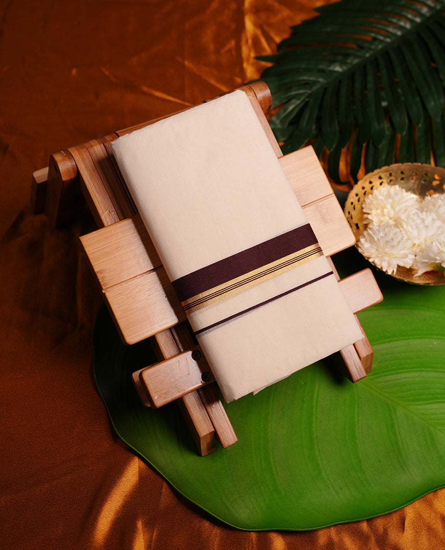 Cream colour cotton double dhoti featuring dark brown and gold border.