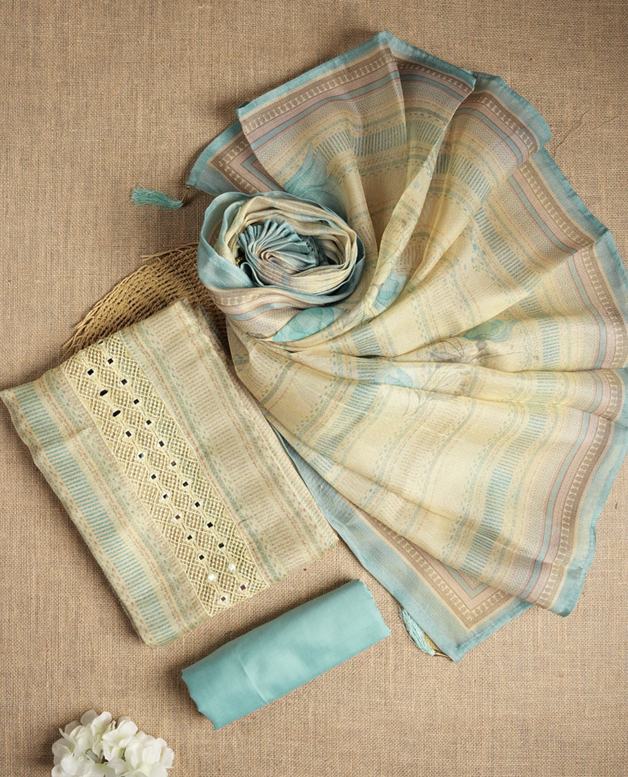 Sky blue and beige colour suit material with delicate woven mirror work patterns and subtle zari detailing & Includes a soft dupatta with a floral touch and plain matching bottom.