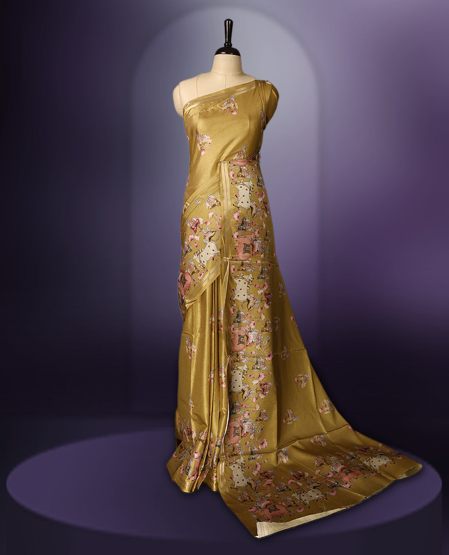 Medallion yellow color saree adorned with charming pastel floral and figure prints all over the body and pallu, lending a whimsical touch & The soft sheen adds elegance, and its paired with a matching blouse piece.