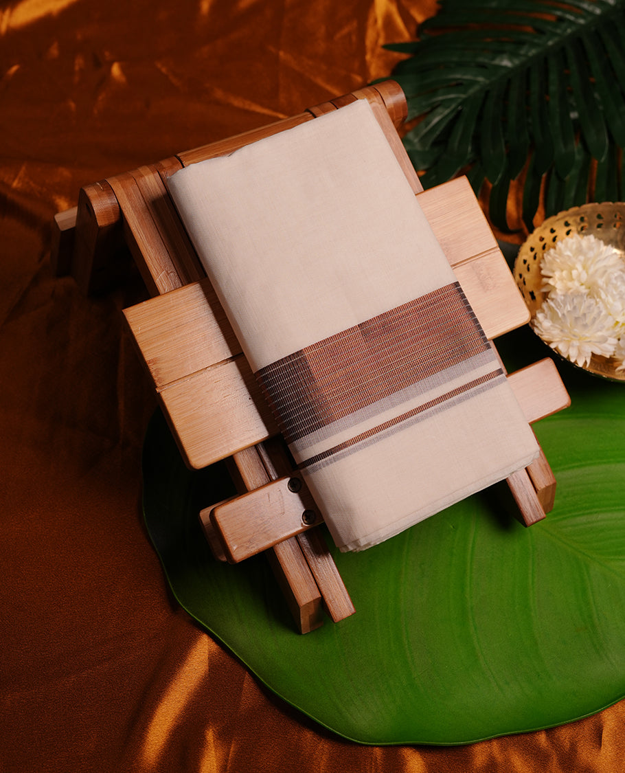 Cream colour cotton double dhoti featuring 3 inch copper colour border