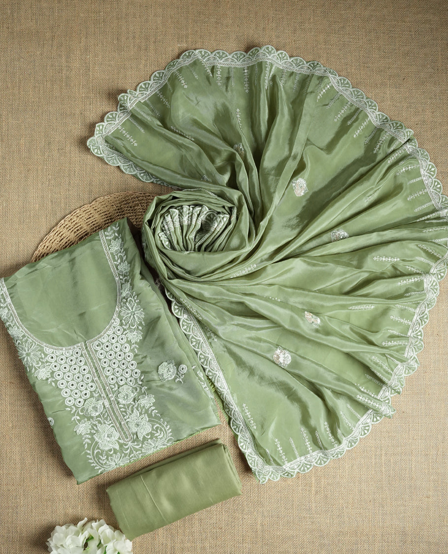 Pastel green colour suit material adorned with elegant white thread , cut beads & sequin embroidery, highlighted by a delicate lace border & Paired with a matching embroidered dupatta and plain bottom.