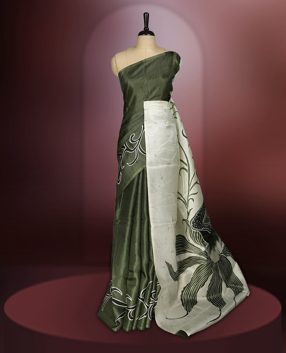 Olive green colour saree with striking off white floral patterns, merging modern minimalism with timeless charm & paired with a matching blouse.