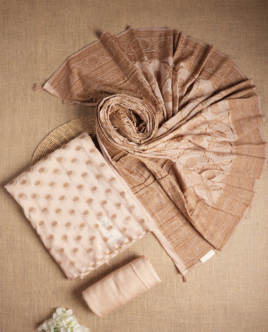 Elegant beige colour suit material adorned with subtle golden designs, exuding timeless charm & Paired with a beautifully woven dupatta and a matching plain bottom.