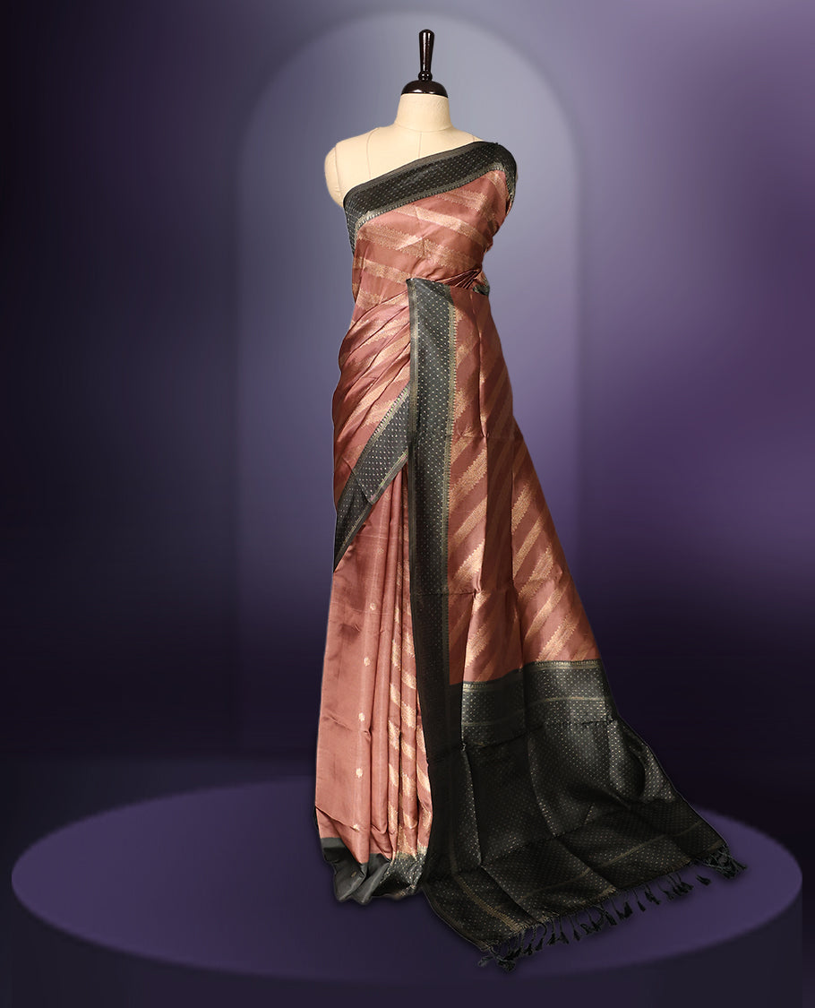 Golden Peach colour saree featuring subtle self striped woven patterns on the body, enhanced with a olive green geometric border, complemented by a rich zari pallu with tassels, and paired with a matching blouse for a traditional elegant look.