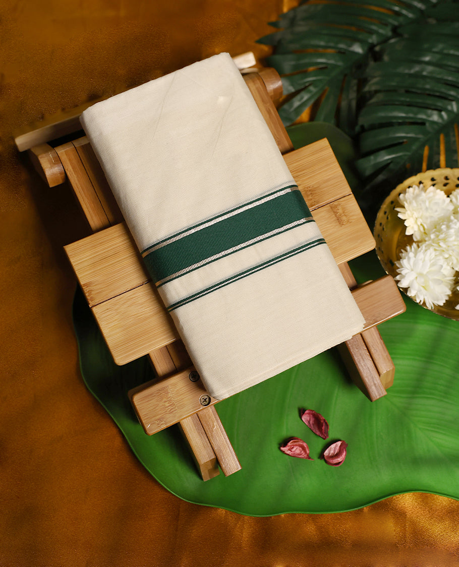 Off white colour cotton double dhoti featuring a classic deep green border with fine stripe accents, offering a simple yet graceful traditional look perfect for rituals, weddings, and festive occasions.