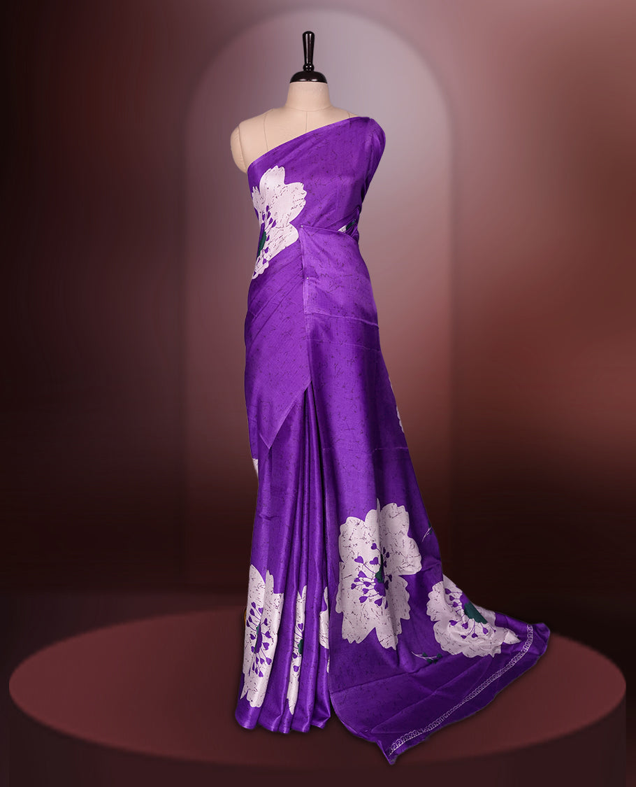 Purple colour saree highlighted with bold white floral prints, blending contemporary style with ethnic grace and paired with a matching blouse.