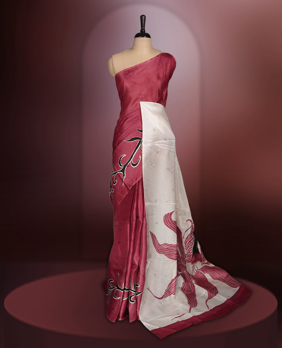 Vivid maroon colour saree adorned with bold off white floral prints, blending tradition with a modern twist & paired with a matching blouse.