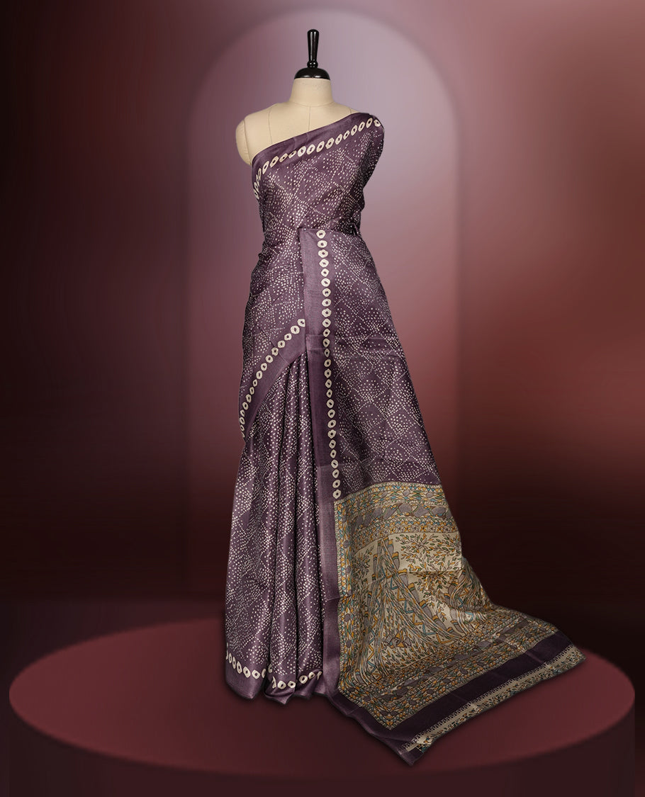 Light Wine colour saree adorned with intricate beige bandhani patterns and a contrasting pallu featuring exquisite beige floral motifs, perfectly paired with a matching blouse for a regal look.