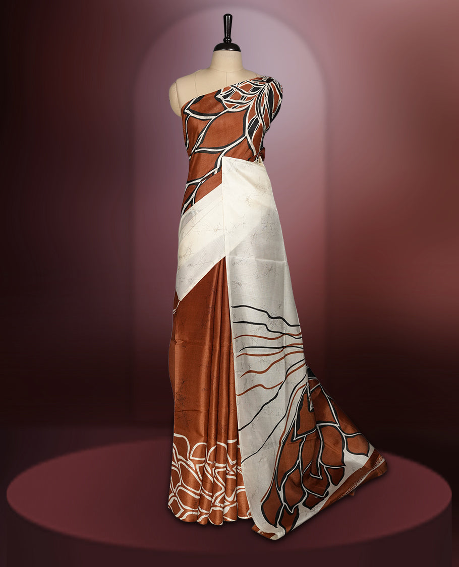 Brown and off white colour saree featuring bold abstract floral patterns, blending contemporary black colour design with ethnic elegance & paired with a matching blouse.