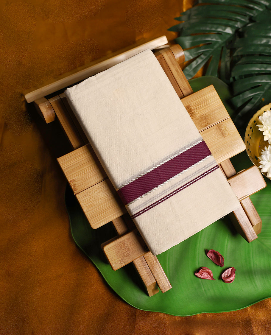 Off white pure cotton double dhoti featuring a rich grape border highlighted with silver zari stripe detailing, offering a traditional and sophisticated look perfect for cultural and festive wear.