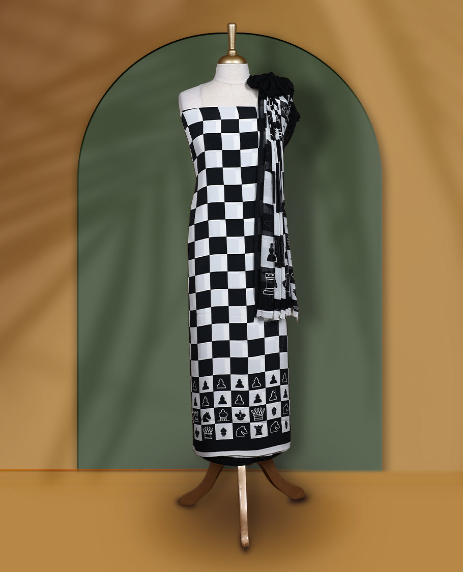 Black & white churidar set featuring a crepe top with chessboard and character prints, paired with a plain santoon bottom and a georgette dupatta adorned with chess coin prints.